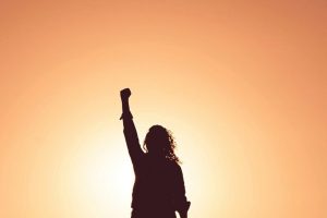 silhouette-of-woman-raising-fist