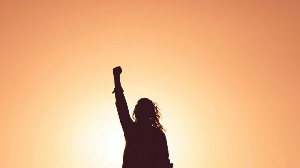 silhouette-of-woman-raising-fist