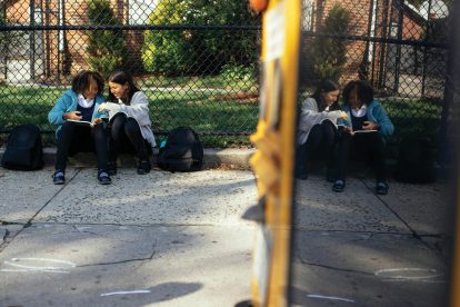 two-school-children-waiting-for-bus