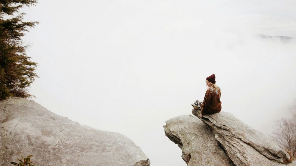 woman sitting-alone-on-cliff