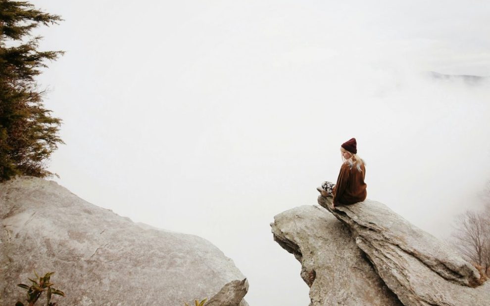 woman sitting-alone-on-cliff