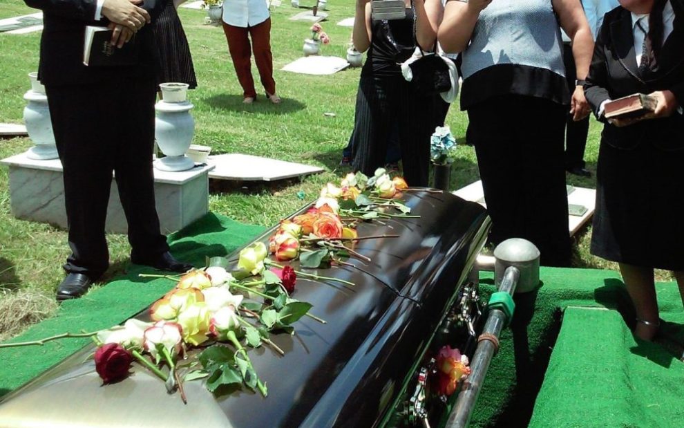 laying-flowers-on-casket-at-a-catholic-funeral