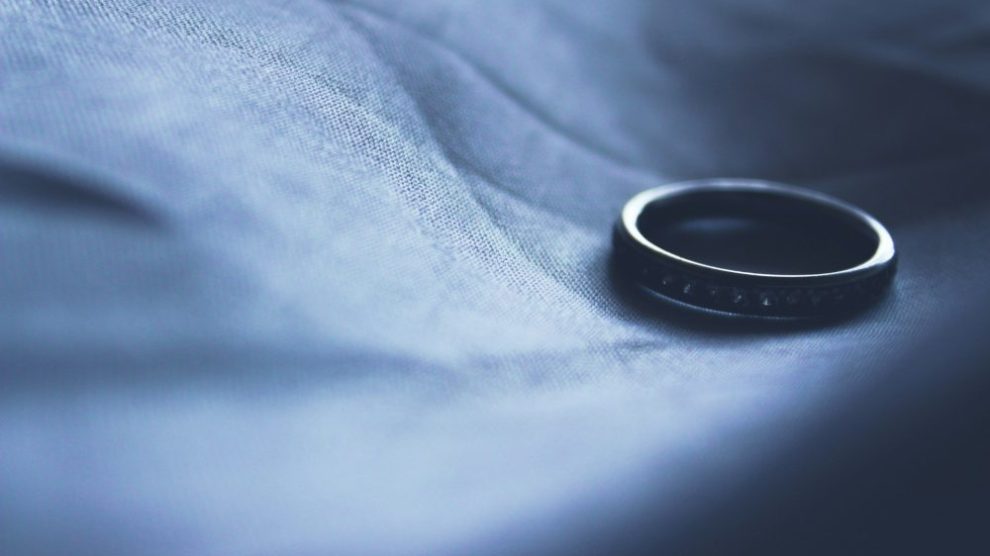 lone-wedding-ring-on-dark-background