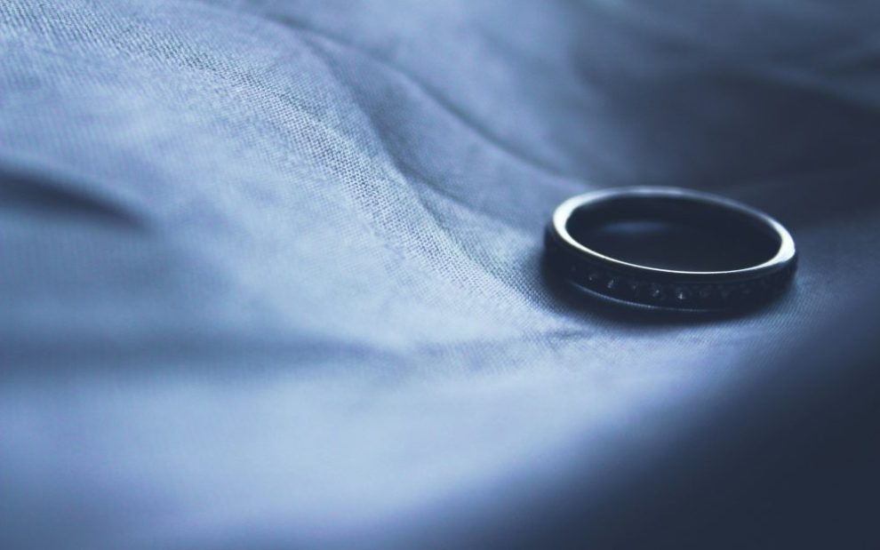 lone-wedding-ring-on-dark-background