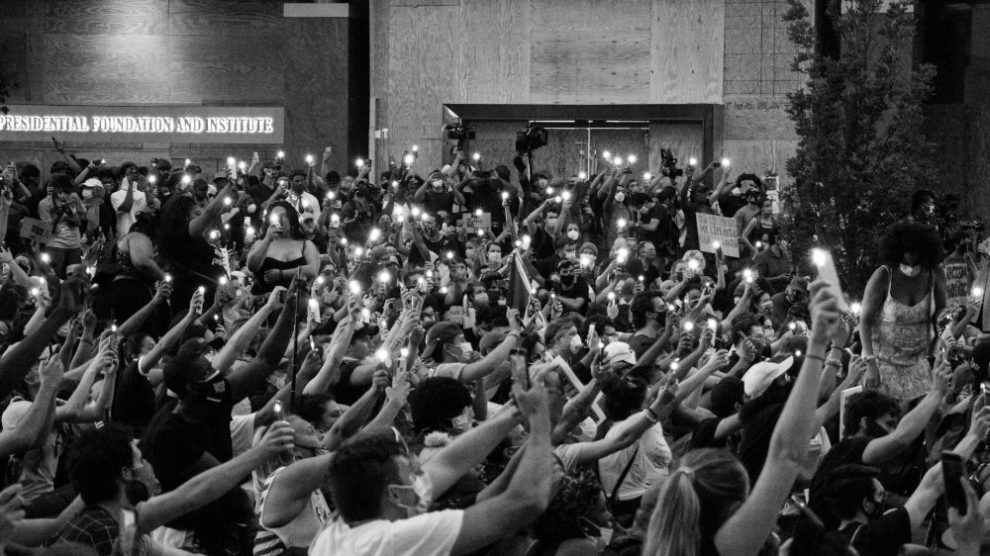 group-of-protesters-with-candles-us-catholic