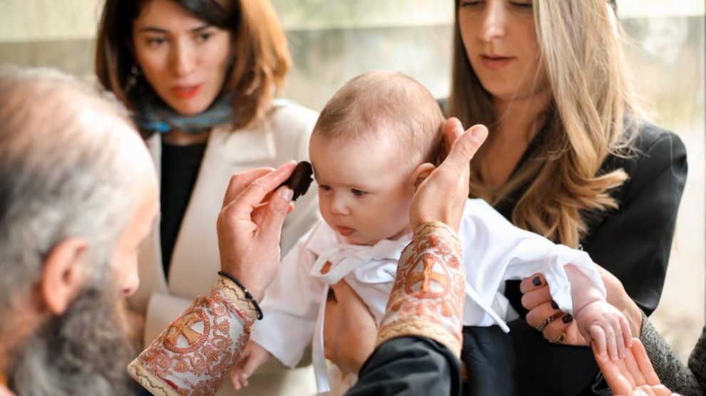 u-s-catholic-baby-at-baptism-with-godparents