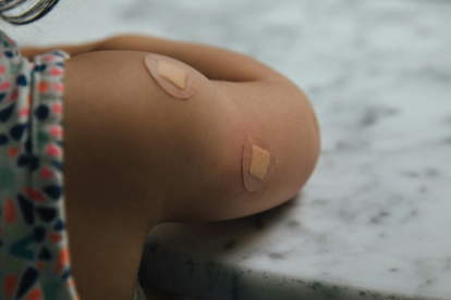 u-s-catholic-child-with-bandages-from-vaccination