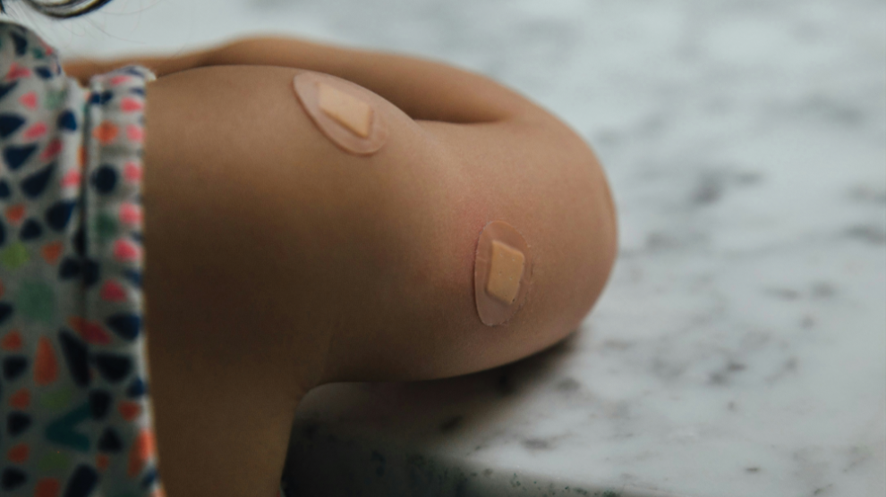u-s-catholic-child-with-bandages-from-vaccination