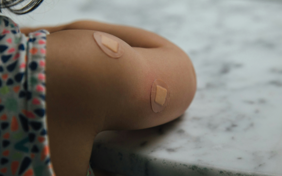 u-s-catholic-child-with-bandages-from-vaccination
