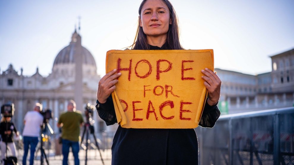 u-s-catholic-woman-with-sign-hope-for-peace
