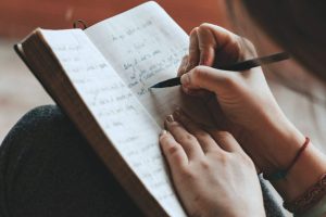 u-s-catholic-person-writing-in-journal