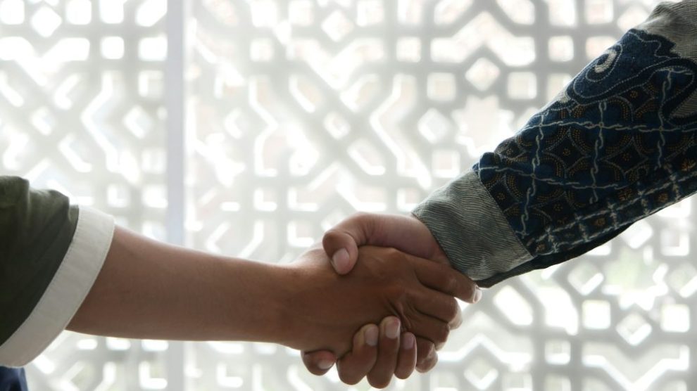 u-s-catholic-two-people-shaking-hands