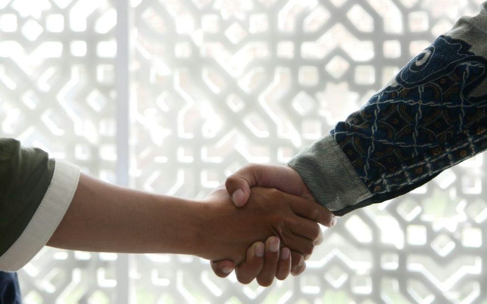 u-s-catholic-two-people-shaking-hands
