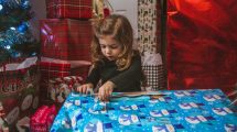 u-s-catholic-little-girl-unwrapping-present