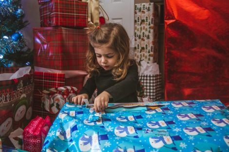 u-s-catholic-little-girl-unwrapping-present