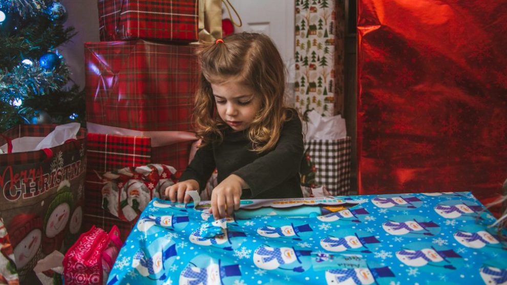 u-s-catholic-little-girl-unwrapping-present