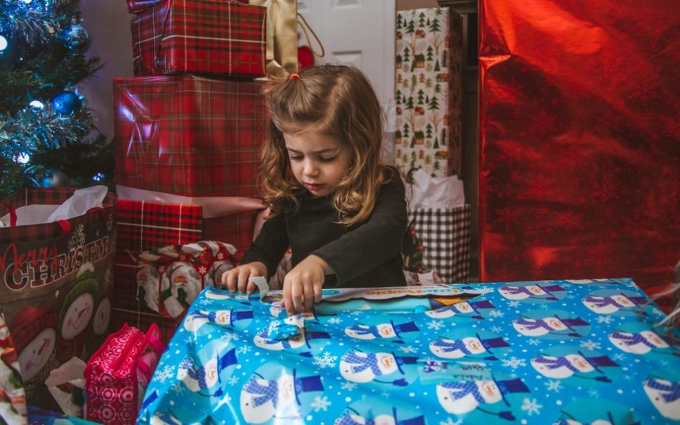 u-s-catholic-little-girl-unwrapping-present