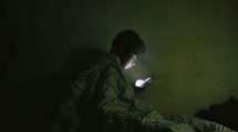 Man Using Internet in Bed - US Catholic - Images