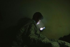 -u-s-catholic-man-using-internet-in-bed