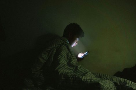 -u-s-catholic-man-using-internet-in-bed