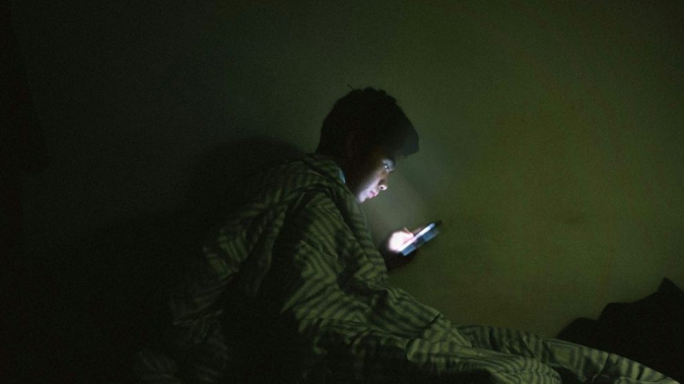 -u-s-catholic-man-using-internet-in-bed