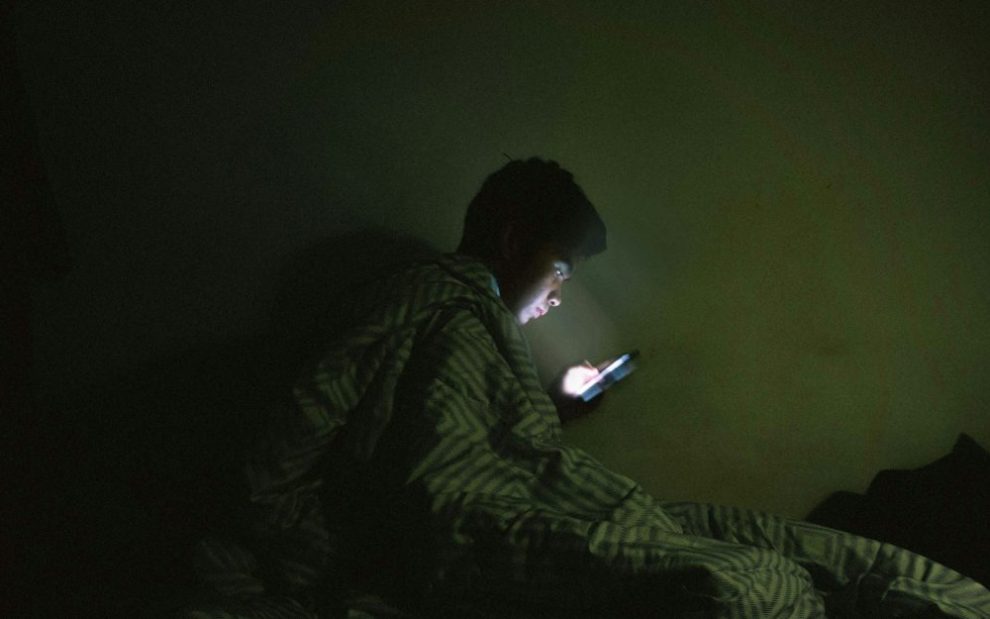 -u-s-catholic-man-using-internet-in-bed