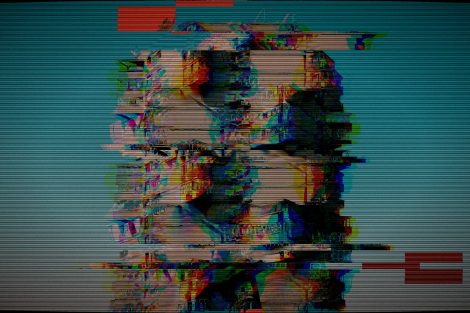 Distorted heads on a glitchy television screen