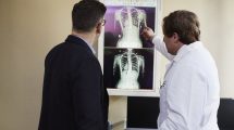 two men look at an xray