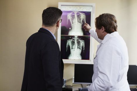 two men look at an xray