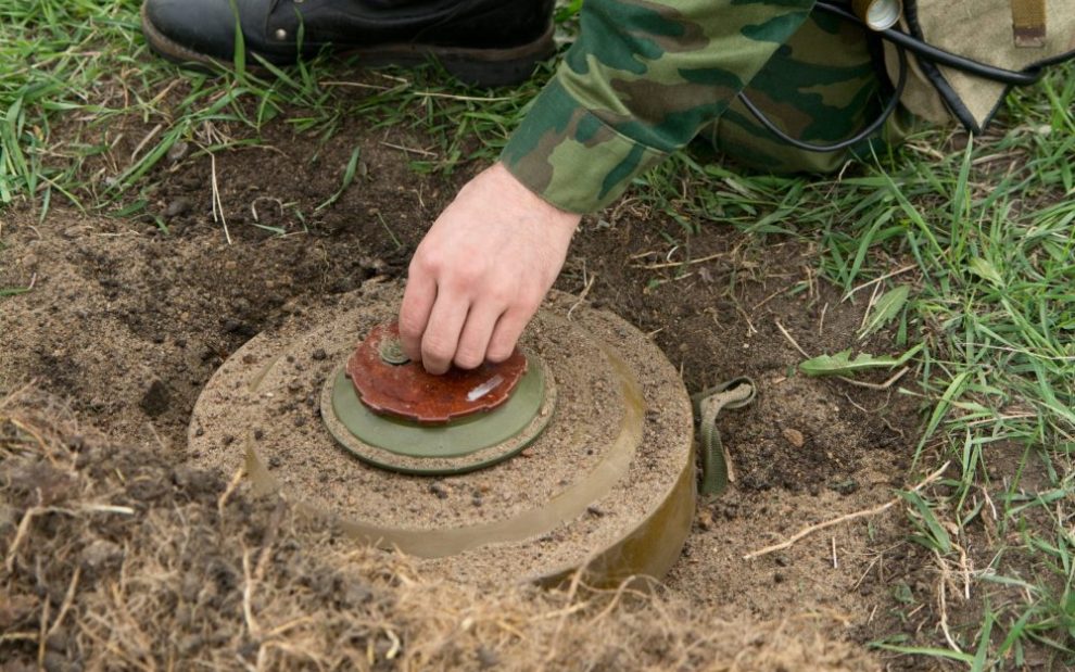 Soldier inspects undetonated landmine