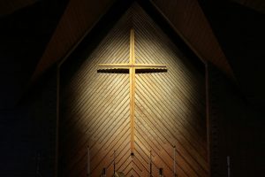 Cross illuminated in a dark room