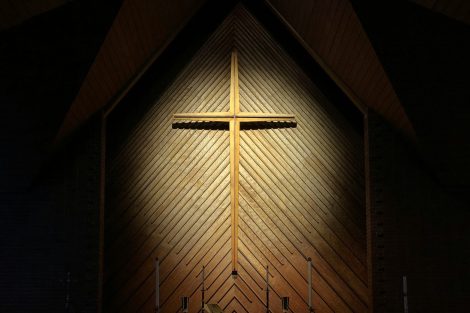 Cross illuminated in a dark room