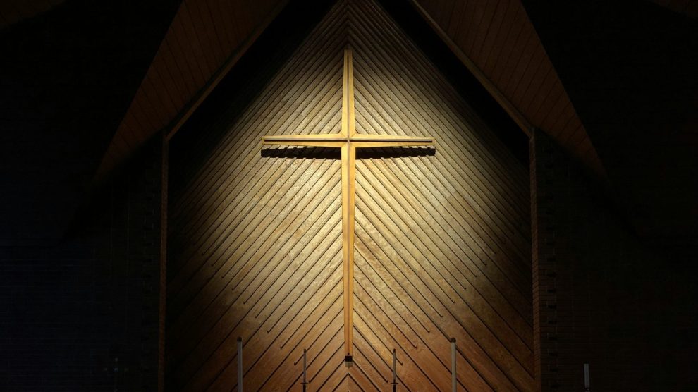 Cross illuminated in a dark room