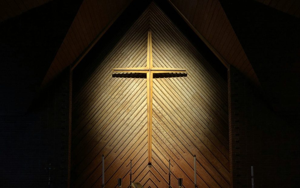 Cross illuminated in a dark room