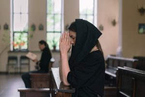 A woman wearing a veil in church