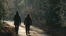 Two people walking down a path together