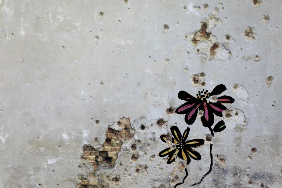 Flowers painted over bullet holes in a wall