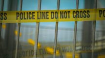 Crime scene tape on a gate