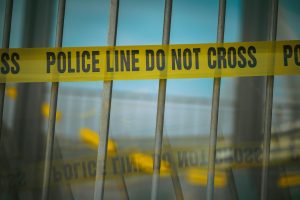 Crime scene tape on a gate