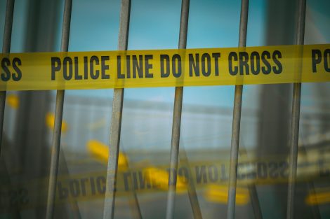 Crime scene tape on a gate