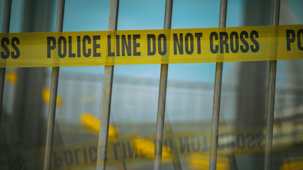 Crime scene tape on a gate