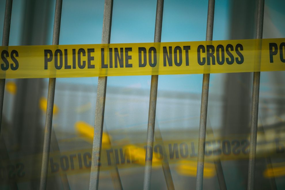 Crime scene tape on a gate