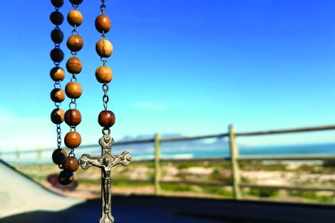 rosary hanging from rearview mirror
