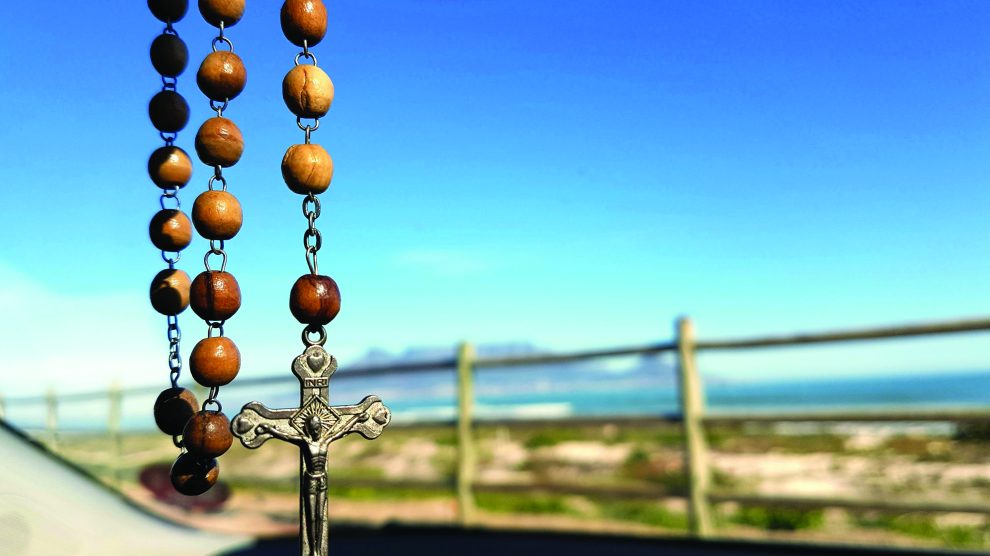 rosary hanging from rearview mirror
