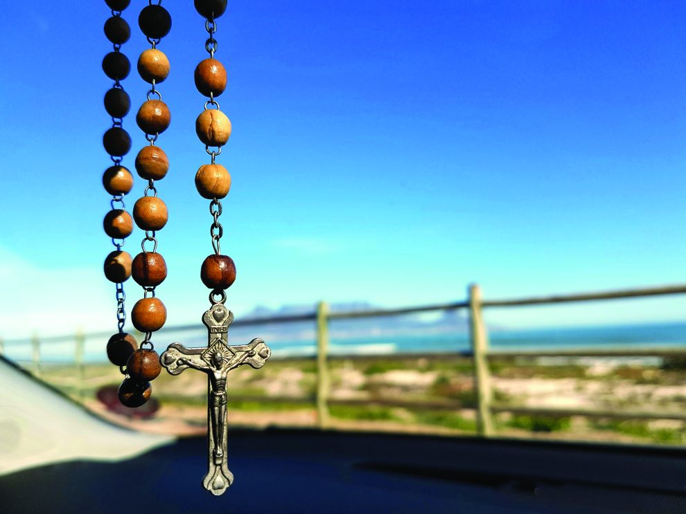 rosary hanging from rearview mirror