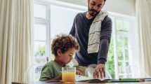Father making his son do his school home work
