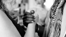 Black person and white person grasping each other's hand