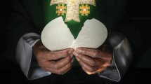 Priest breaking the Eucharit