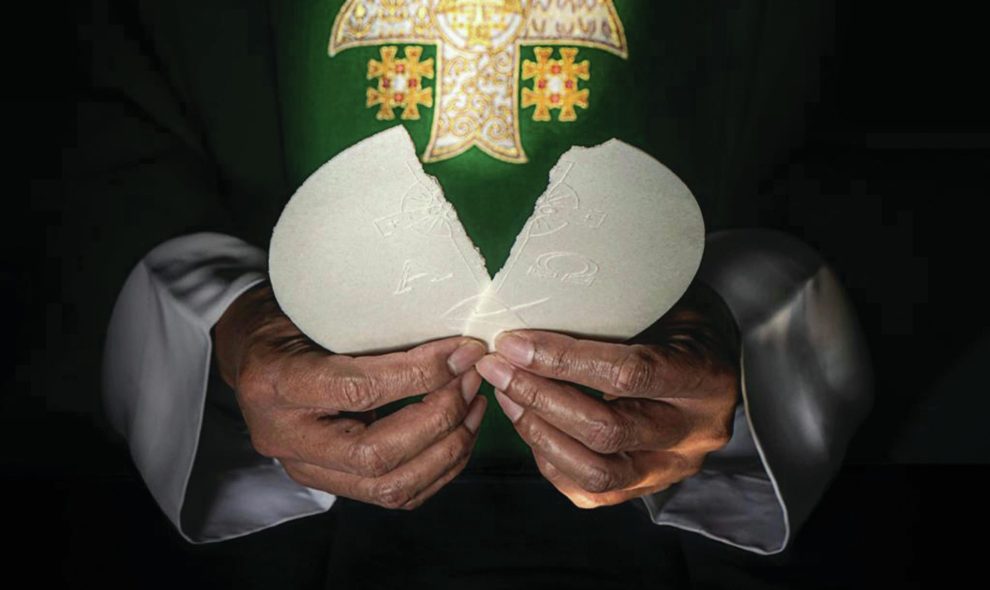 Priest breaking the Eucharit