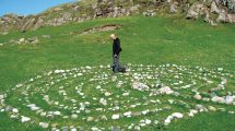 Man walks a labyrinth made out of stones